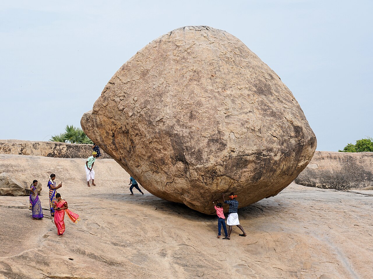 Krishna's butterball, 6 m (20 ft) high, 5 m (16 ft) wide, weighs around 250 tonnes, granite boulder, view from SE. Mahabalipuram, Tamil Nadu, India