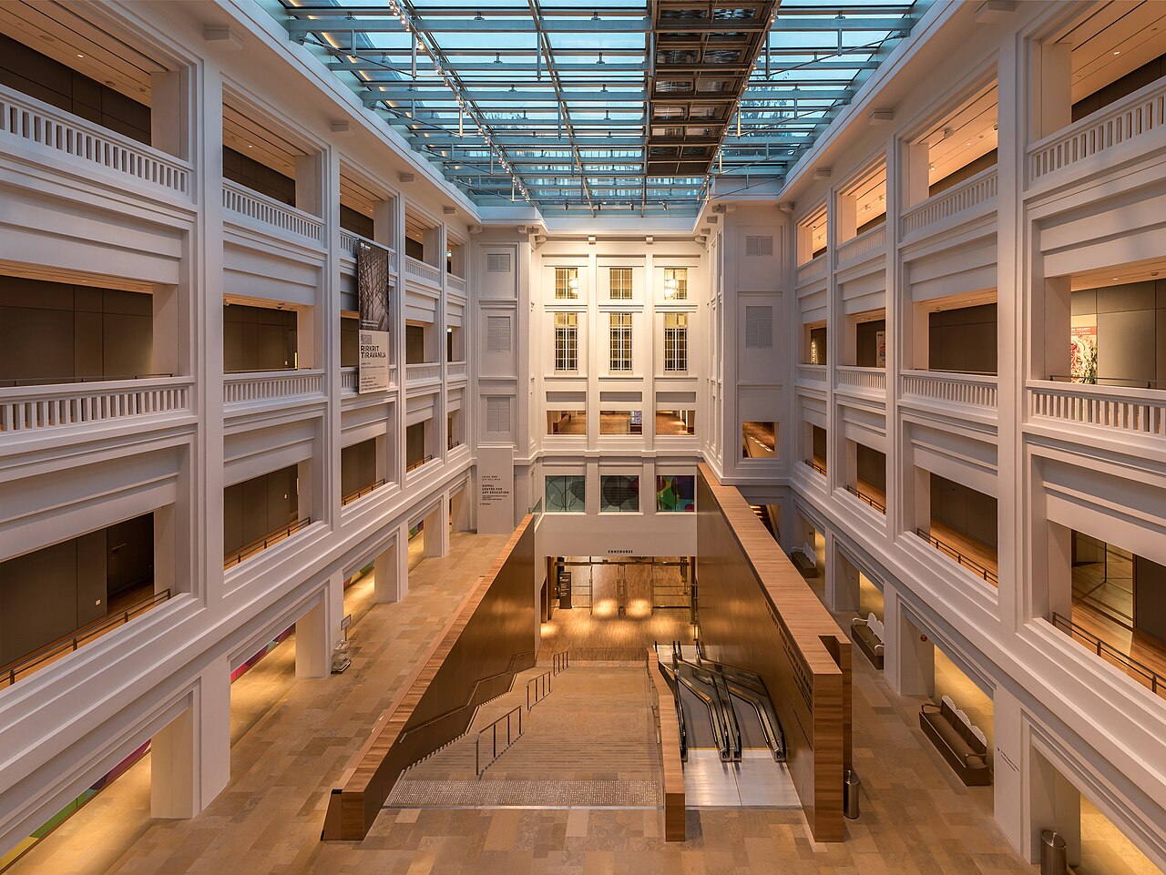 Interior of the National Gallery of Singapore with the airy corridors on 4 levels, the staircases and escalators, in the evening. Architect : Jean-Francois Milo